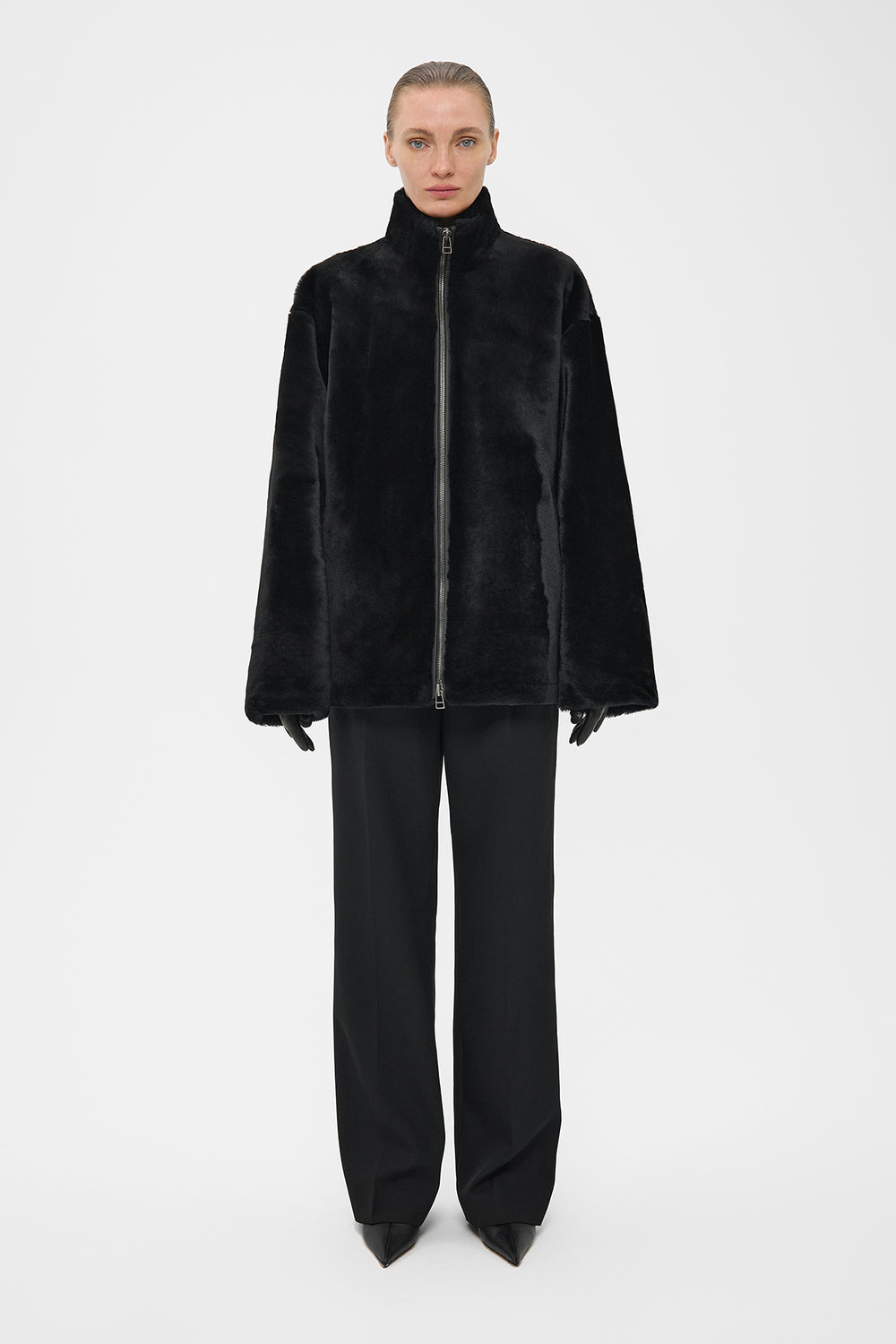 SILKY ELONGATED SHEARLING BOMBER JACKET IN BLACK